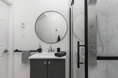 a bathroom with a sink and a mirror at Brand new 2 bedroom in the heart of the city in Montréal