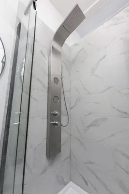 a shower with a glass door in a bathroom at Brand new 2 bedroom in the heart of the city in Montréal