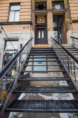 a set of stairs leading to a building with a door at Studio #1 - Self Check-In - Plateau - St-Denis in Montréal