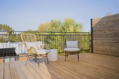 two chairs sitting on top of a wooden deck at Studio #2 - Self Check-In - Plateau - St-Denis in Montréal