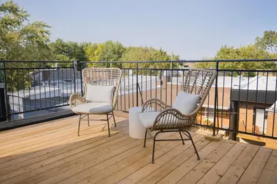 three chairs sitting on a deck on a balcony at Studio #7 - Self Check-In - Plateau - St-Denis in Montréal