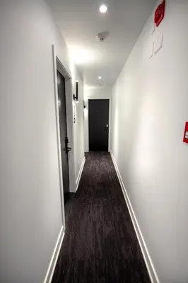 an empty hallway with a black door and a room at Studio #8 - Self Check-In - Plateau - St-Denis in Montréal