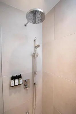a shower with a shower head in a bathroom at Studio #9 - Self Check-In - Plateau - St-Denis in Montréal