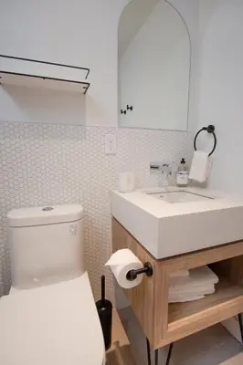 a bathroom with a sink and a toilet and a mirror at Studio #11 - Self Check-In - Plateau - St-Denis in Montréal