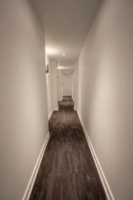 an empty hallway with white walls and a carpet at Studio #12 - Self Check-In - Plateau - St-Denis in Montréal