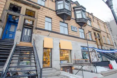 a building with a blue door on a street at Studio #12 - Self Check-In - Plateau - St-Denis in Montréal