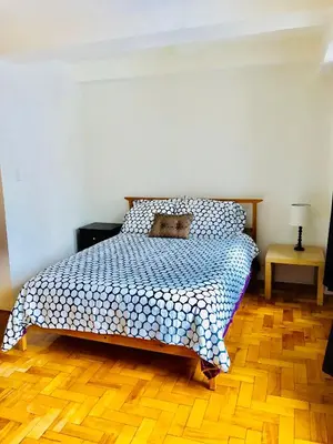 a bedroom with a bed with a teddy bear on it at Stylish Montreal Apartment Comfortable Stay in the Golden Square Mile in Montréal