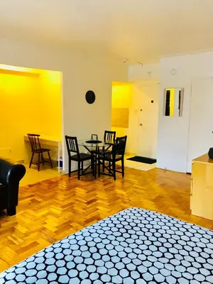 a room with a table and chairs and yellow walls at Stylish Montreal Apartment Comfortable Stay in the Golden Square Mile in Montréal