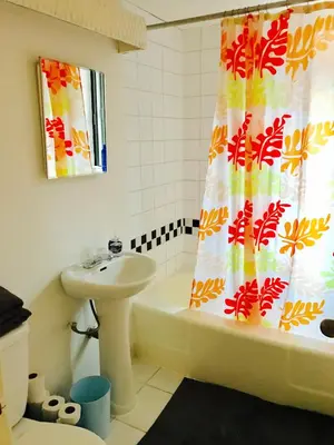 a bathroom with a sink and a shower curtain at Stylish Montreal Apartment Comfortable Stay in the Golden Square Mile in Montréal