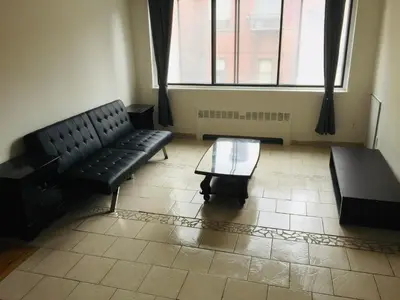 a living room with a couch and a coffee table at Stylish Montreal Apartment Comfortable Stay in the Golden Square Mile in Montréal