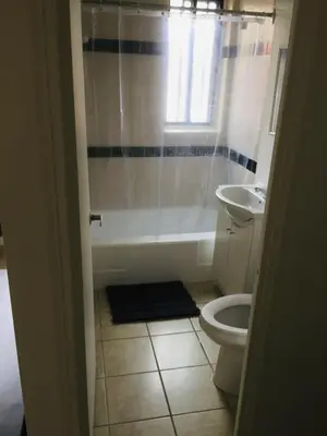 a bathroom with a tub and a toilet and a sink at Stylish Montreal Apartment Comfortable Stay in the Golden Square Mile in Montréal