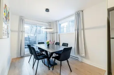 a dining room with a table and chairs at Longueuil New Stylish 3-BDR free parking close to Dix 30&DT in Longueuil