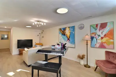 a living room with a piano and a couch at Private Charming Twin Room & Parking in Saint-Bruno-de-Montarville