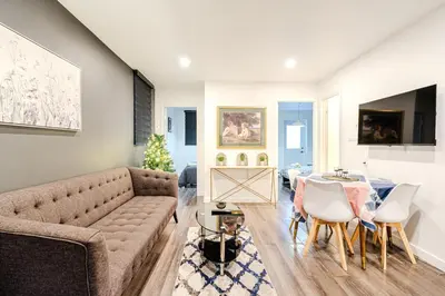 a living room with a couch and a table at Bright stay in Griffin Town in Montréal