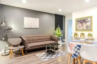 a living room with a couch and a table at Bright stay in Griffin Town in Montréal