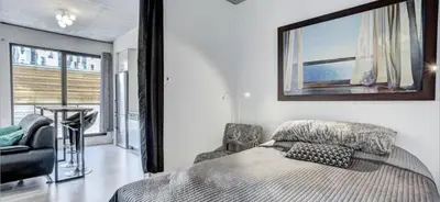 a bedroom with a bed with a picture on the wall at INCh in Montréal