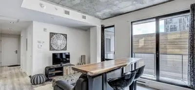 a living room with a desk and a large window at INCh in Montréal