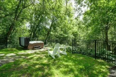 a fence with a bench and a tv in a yard at 853 condo in Bromont Vieux Village mountain view in Bromont