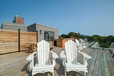 a row of white chairs sitting on a deck at room with private bathroom 837 shefford suite 105 in Bromont