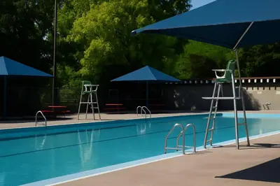 a swimming pool with blue umbrellas and tables and chairs at Bright Renovated 4BR, Heart of Côte-des-Neiges, Montreal in Montréal