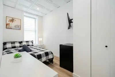 a living room with a bed and a couch at Room n1-Apartment 1 in a SHARED apartment in downtown Montreal in Montréal