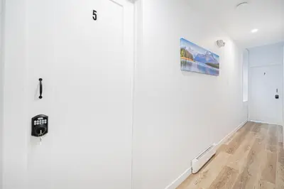 a room with white walls and a door with a picture at Room n1-Apartment 1 in a SHARED apartment in downtown Montreal in Montréal