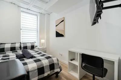a bedroom with a bed and a desk and a chair at Room n2-Apartment 1 in a SHARED apartment in downtown Montreal in Montréal