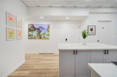a white kitchen with a counter and paintings on the wall at Room n3-Apartment 1 in a SHARED apartment in downtown Montreal in Montréal