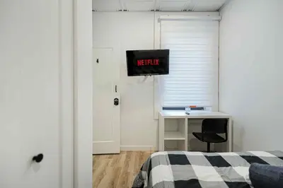 a bedroom with a bed and a desk with a monitor at Room n4-Apartment 1 in a SHARED apartment in downtown Montreal in Montréal