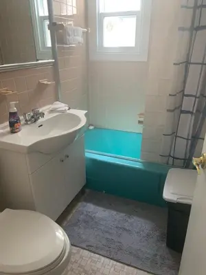 a bathroom with a sink and a toilet and a tub at Montréal Downtown Private Rooms Across Polytechnique in Montréal