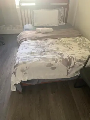 a bed in a room with a wooden floor at Montréal Downtown Private Rooms Across Polytechnique in Montréal