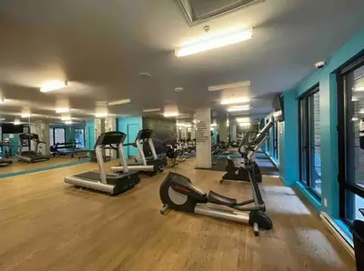 a gym with several treadmills and elliptical machines at Loft moderne au coeur de Montreal in Montréal