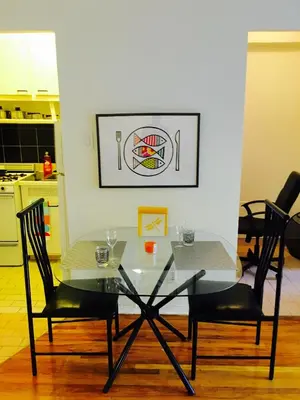 a glass table and two chairs in a kitchen at Stylish Montreal Apartment Comfortable Stay in the Golden Square Mile in Montréal
