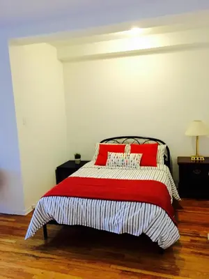 a bedroom with a bed with red pillows on it at Stylish Montreal Apartment Comfortable Stay in the Golden Square Mile in Montréal