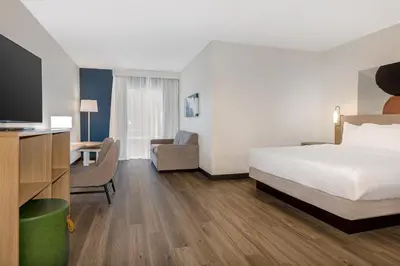 a hotel room with a bed and a desk and a tv at Spark By Hilton Montreal Midtown in Montréal