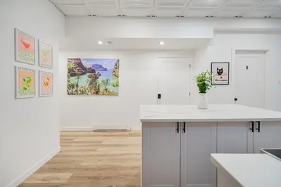 a kitchen with a counter and paintings on the wall at Chambre 3 - Appartement 2 dans un appartement PARTAGÉ in Montréal