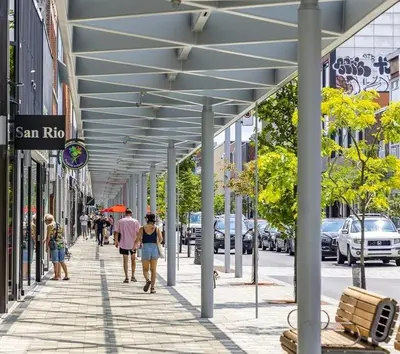 a group of people walking down a sidewalk at Shope & Stay Central 7 in Montréal