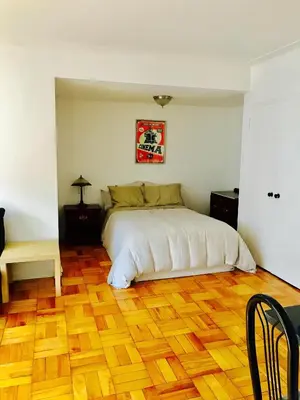a bedroom with a bed and a wooden floor at Modern Apartment City Living in the Golden Square Mile in Montréal