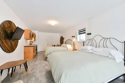 a hotel room with two beds and a tv at Studio à Val-Racine - Ciel étoilé, Mont-Mégantic in Notre-Dame-Des-Bois