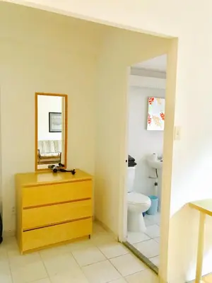 a bathroom with a sink and a toilet and a mirror at Modern City Studio Living in the Golden Square Mile in Montréal