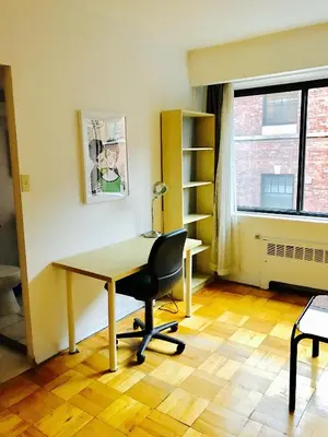 an office with a desk and a chair and a window at Modern City Studio Living in the Golden Square Mile in Montréal