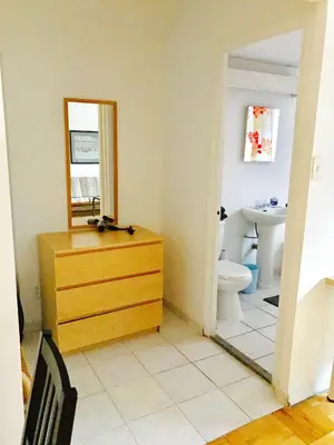 a bathroom with a wooden dresser and a mirror at Modern City Studio Living in the Golden Square Mile in Montréal