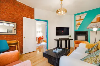 a living room with a brick wall at Unique Downtown Montreal Stay with Private Terrace in Montréal