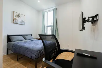 a bedroom with a bed and a tv in it at Escape studio with parking near downtown Montreal in Montréal