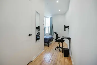 a room with a desk and a chair and a door at Chic Bright Apartment with Parking Near downtown Montreal in Montréal