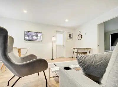 a living room with a couch and a chair at Charmant 2BD in Montréal