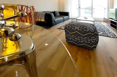 a living room with a glass table and a couch at Corporate Stays Blum 2 Bedrooms in Brossard