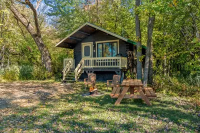 a tiny house in the woods with a picnic table at chalet 4 - Domaine de l'Archipel in Sorel