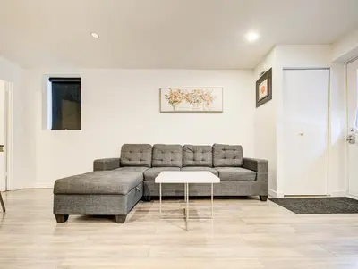 a living room with a couch and a table at Appartement design au cœur de Griffintown in Montréal