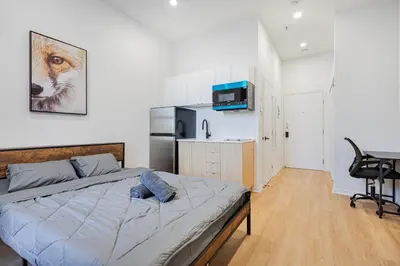 a bedroom with a bed and a desk in it at Affordable Weekly Studio For 2 Guest with Free Parking in Montréal